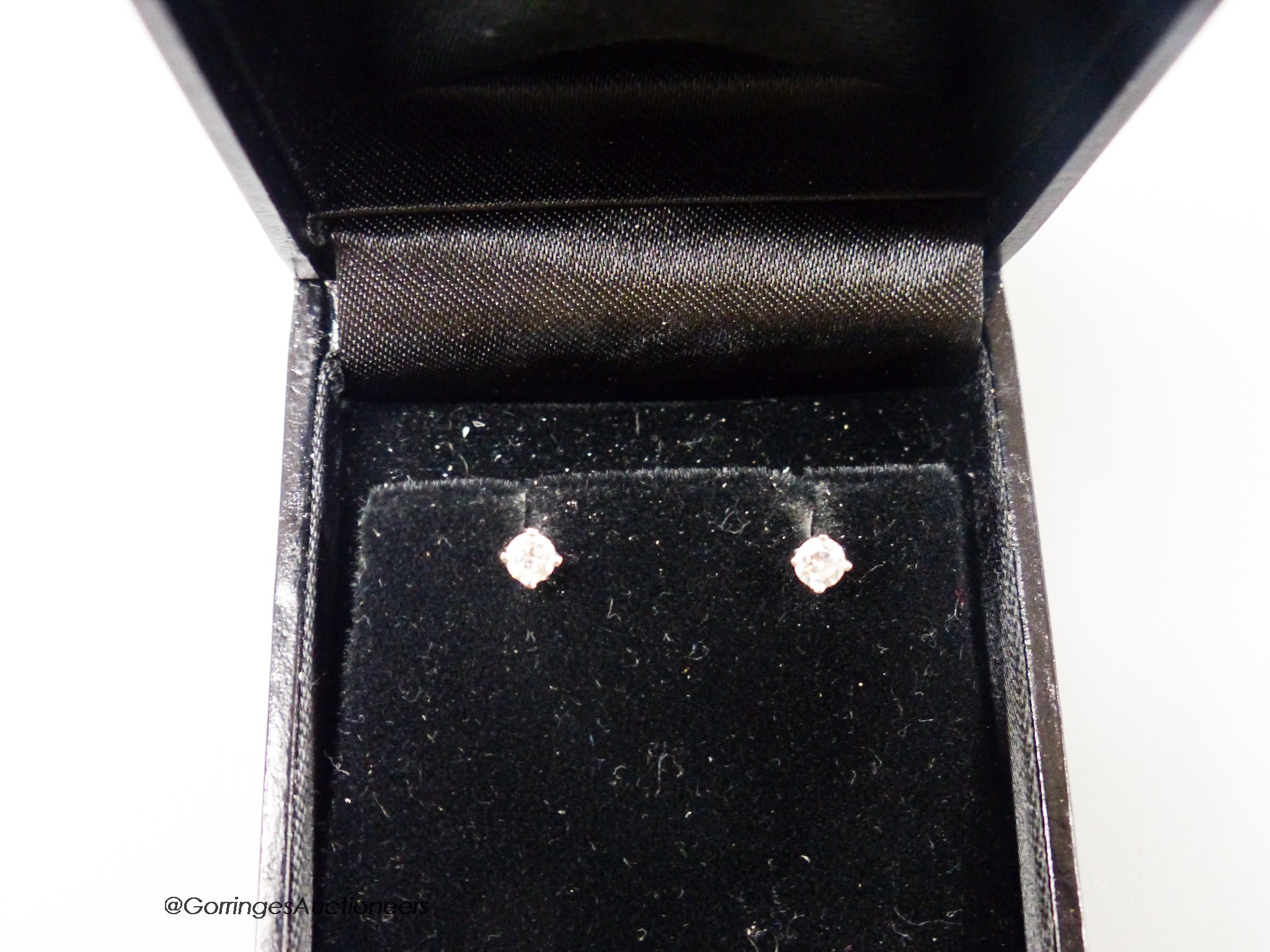 A modern pair of 18ct white gold and solitaire diamond set ear studs, gross weight 1.1 grams, each stone weighing approx.0.12ct.
